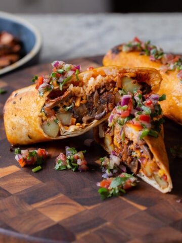 close-up of crispy tofu burrito cut in half so you can see the filling