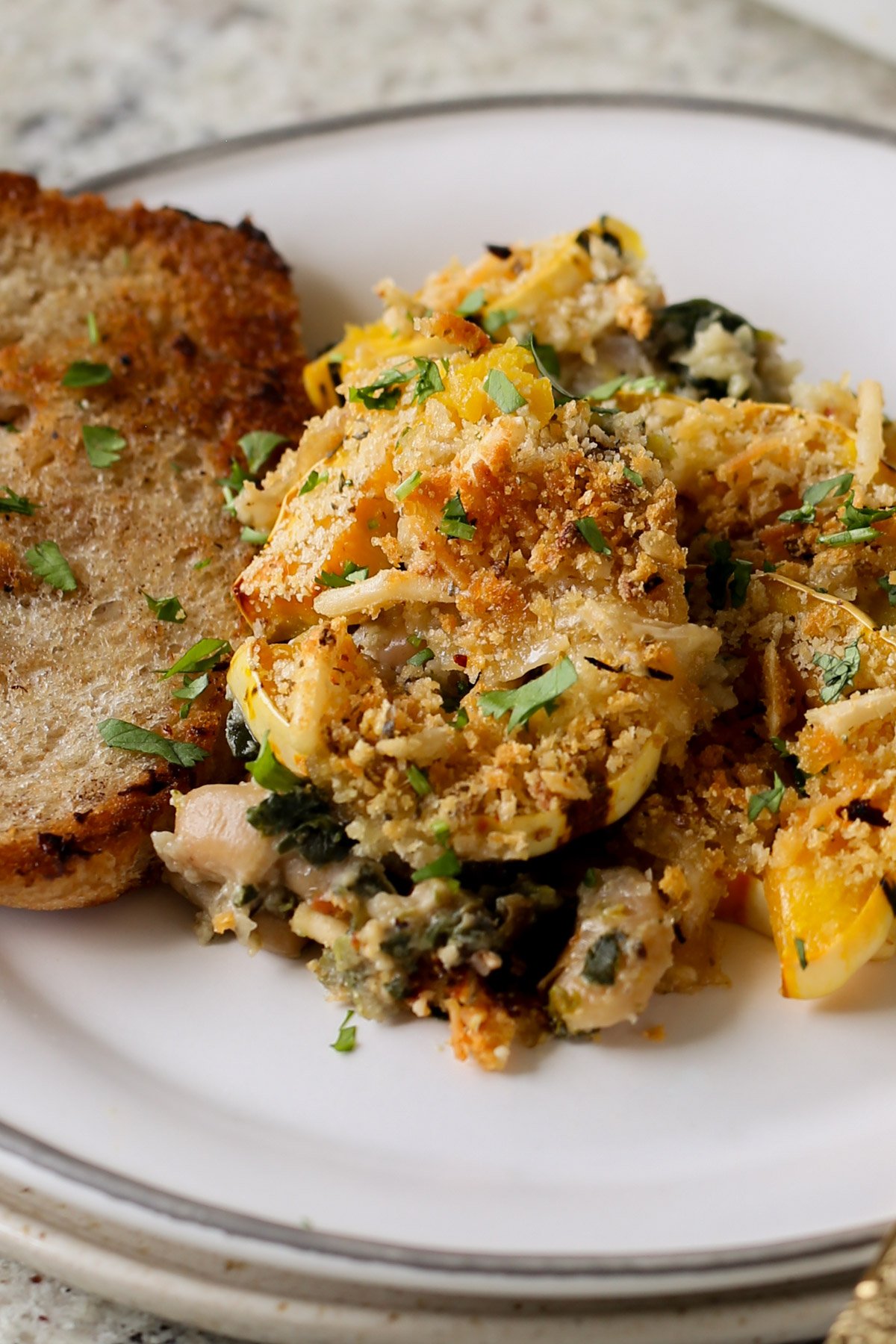 delicata squash casserole on a plate with toast