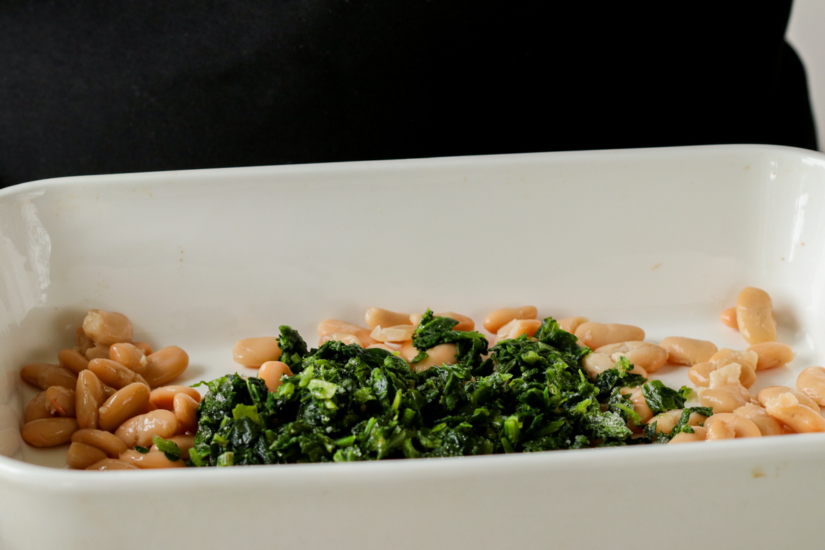 spinach and white beans in the casserole dish