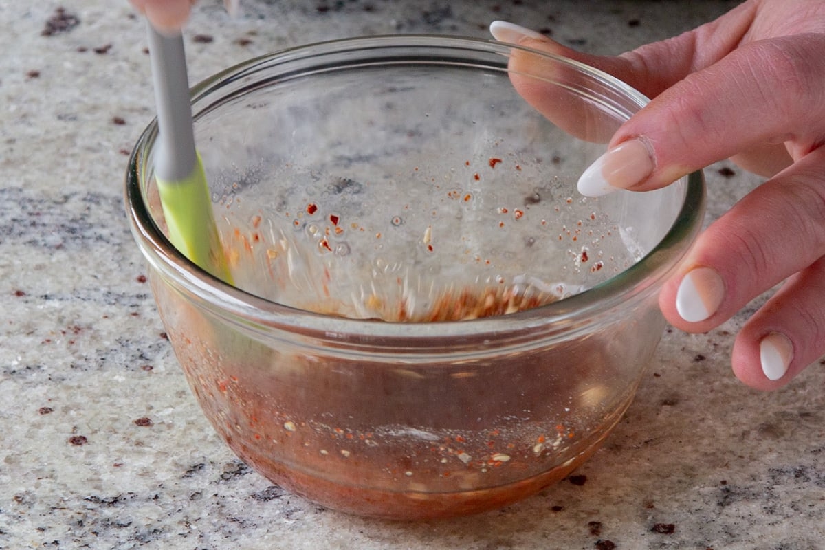 mixing up dressing ingredients in the bowl