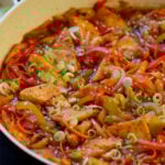 close-up of Szechuan tofu in the pan with green onions and sesame seeds